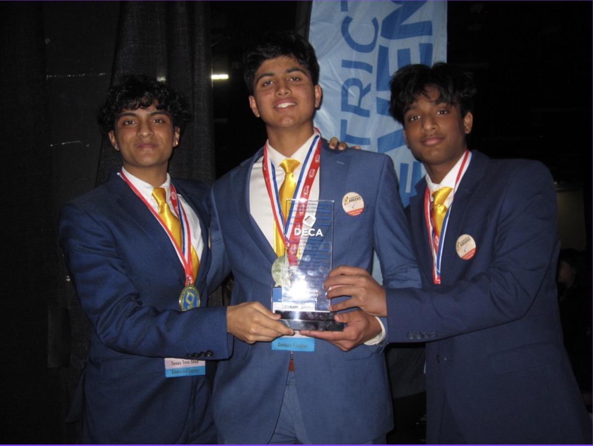Rishit, Ishaan, and Pratik at DECA ICDC with their trophy and medals