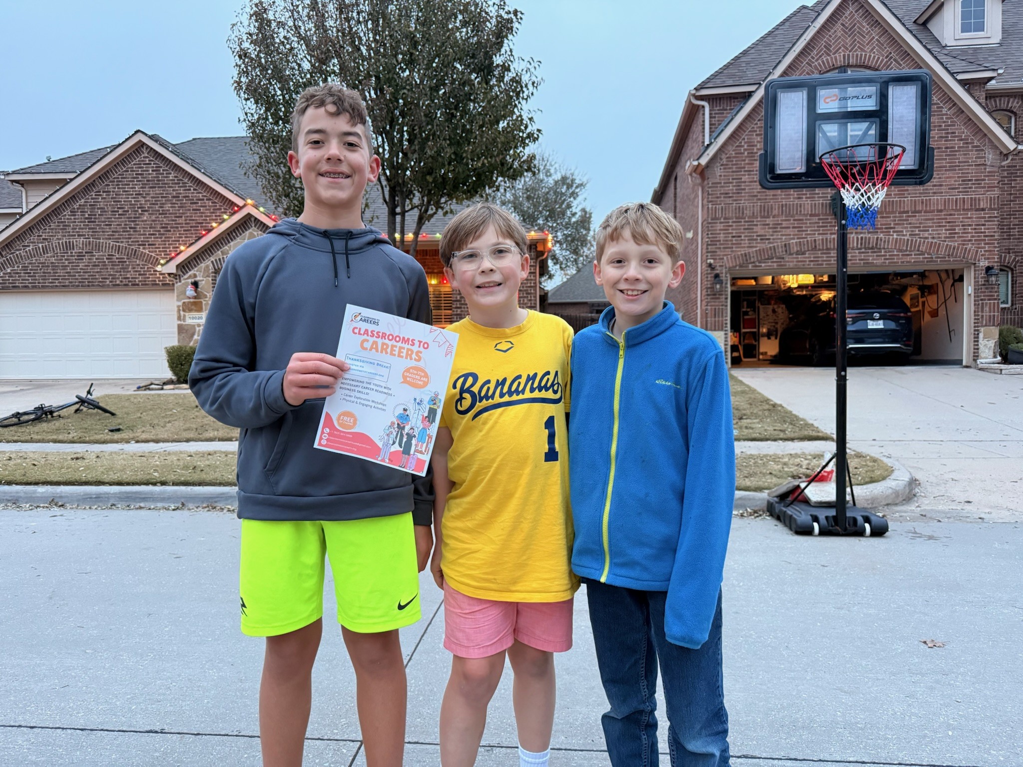 Three students holding a Classrooms to Careers flyer